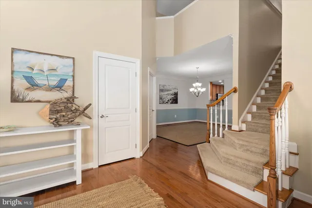 a view of a room with wooden floor and chandelier