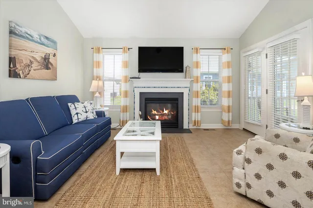 a spacious bedroom with a large bed and a chandelier