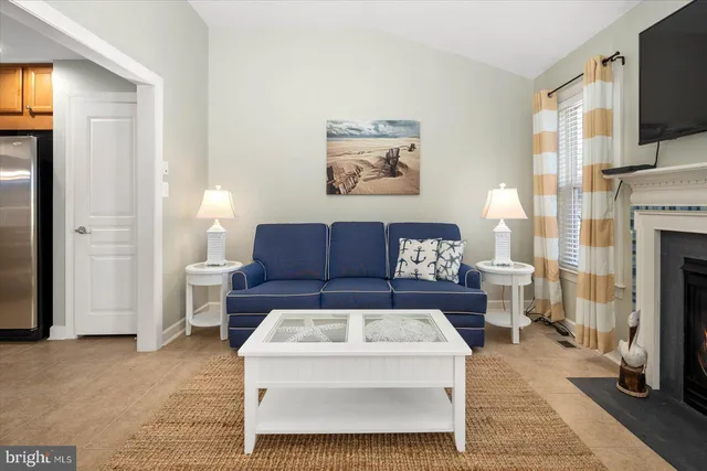 a bedroom with a large bed and a flat tv screen on dresser
