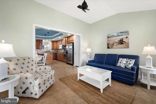 a living room with furniture ceiling fan and a window