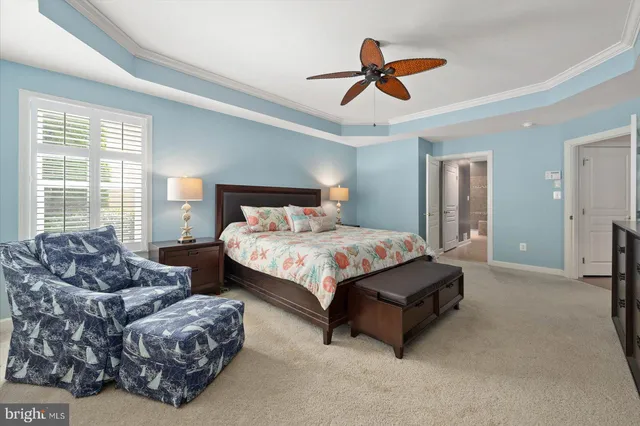 a spacious bedroom with a bed and a window