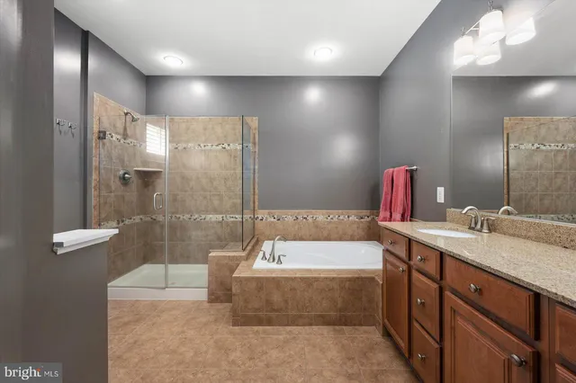 a spacious bedroom with a bed and a ceiling fan