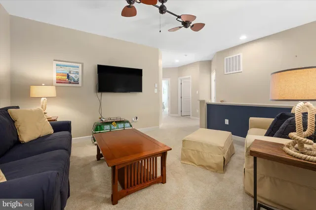 a living room with furniture tv and a large window