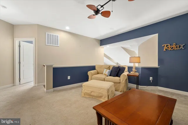 a front view of a house with glass windows and plants
