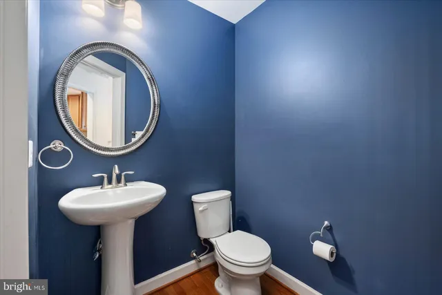 a view of a house with potted plants and a table and chairs