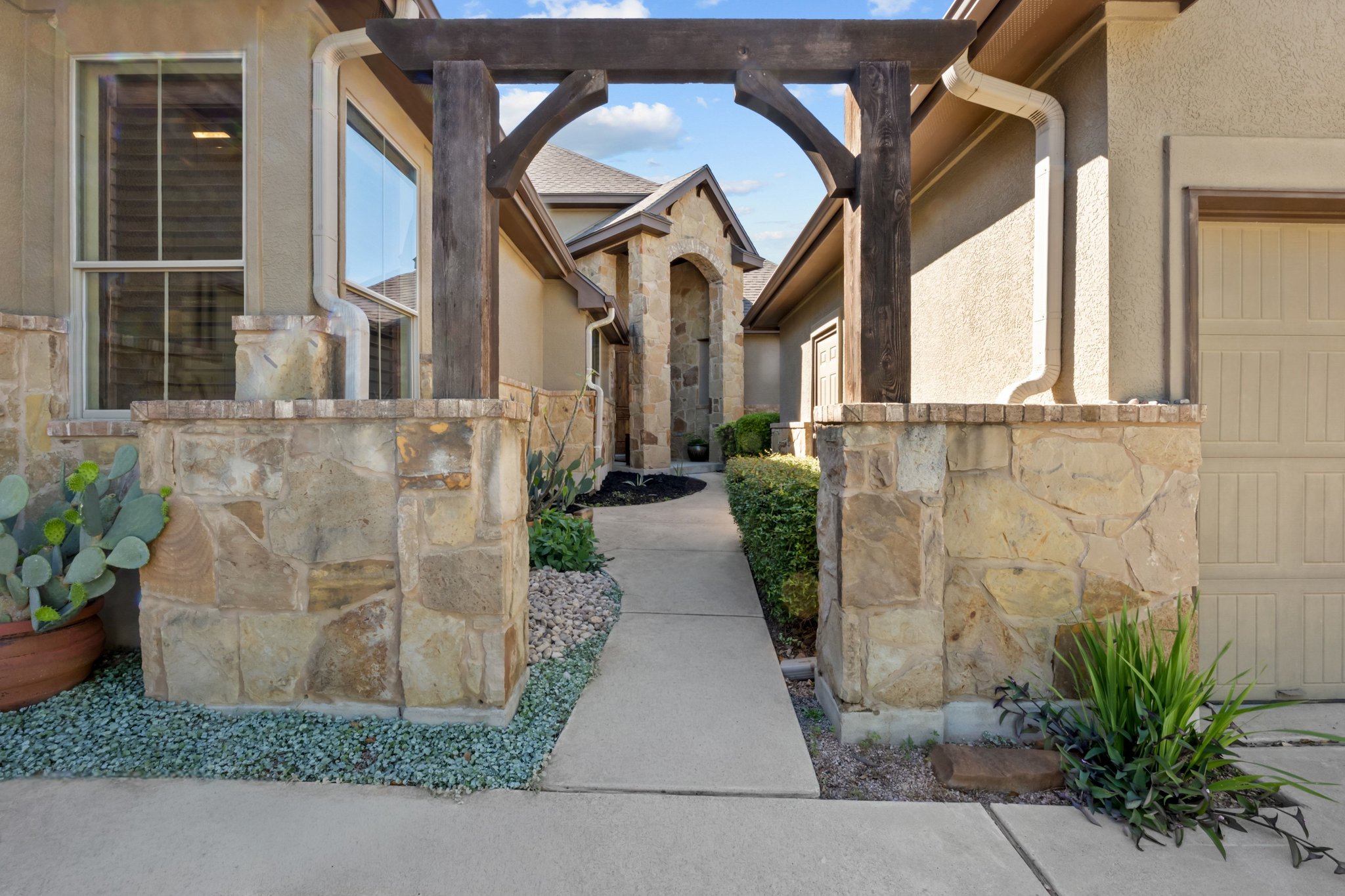 22204 Red Yucca Road Spicewood, TX 78669 - Photo 5 of 34 a view of a pathway both side of house