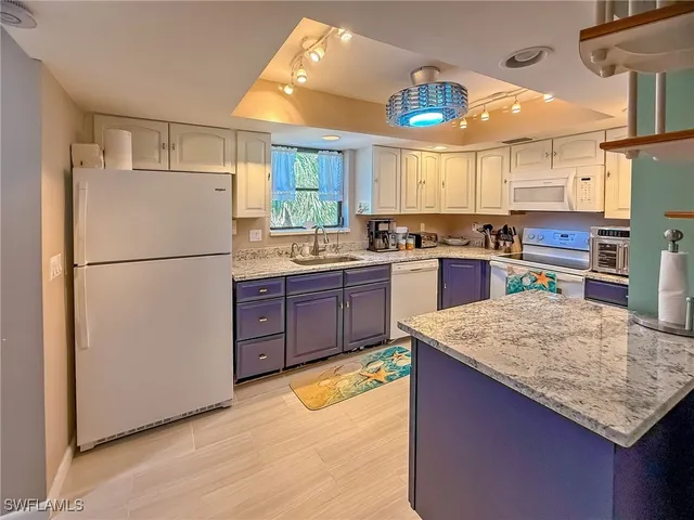 a white refrigerator freezer sitting in a kitchen