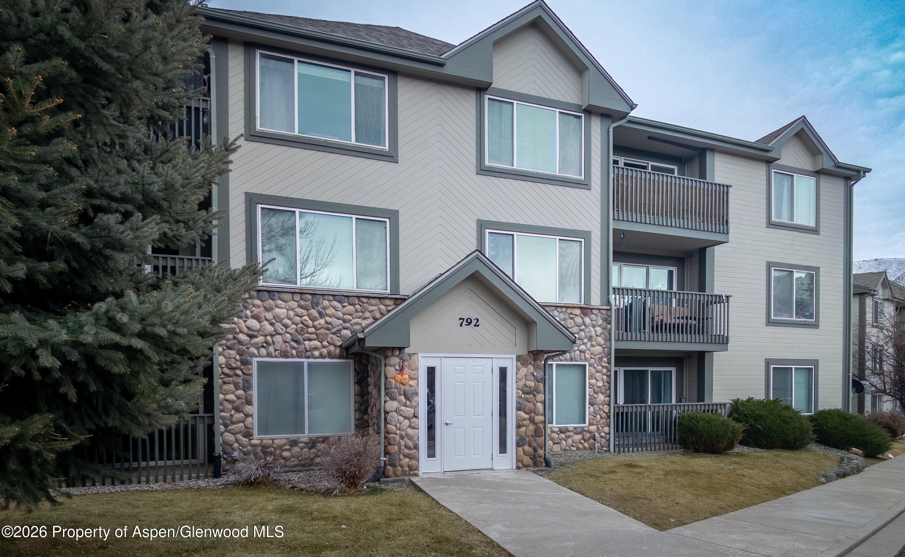 792 Castle Valley Boulevard, Unit B New Castle, CO 81647 - Photo 1 of 25 a front view of a house with garden
