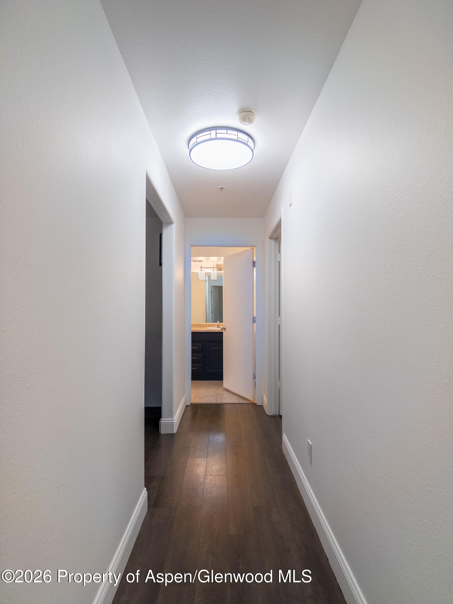 792 Castle Valley Boulevard, Unit B New Castle, CO 81647 - Photo 11 of 25 a view of a hallway with wooden floor