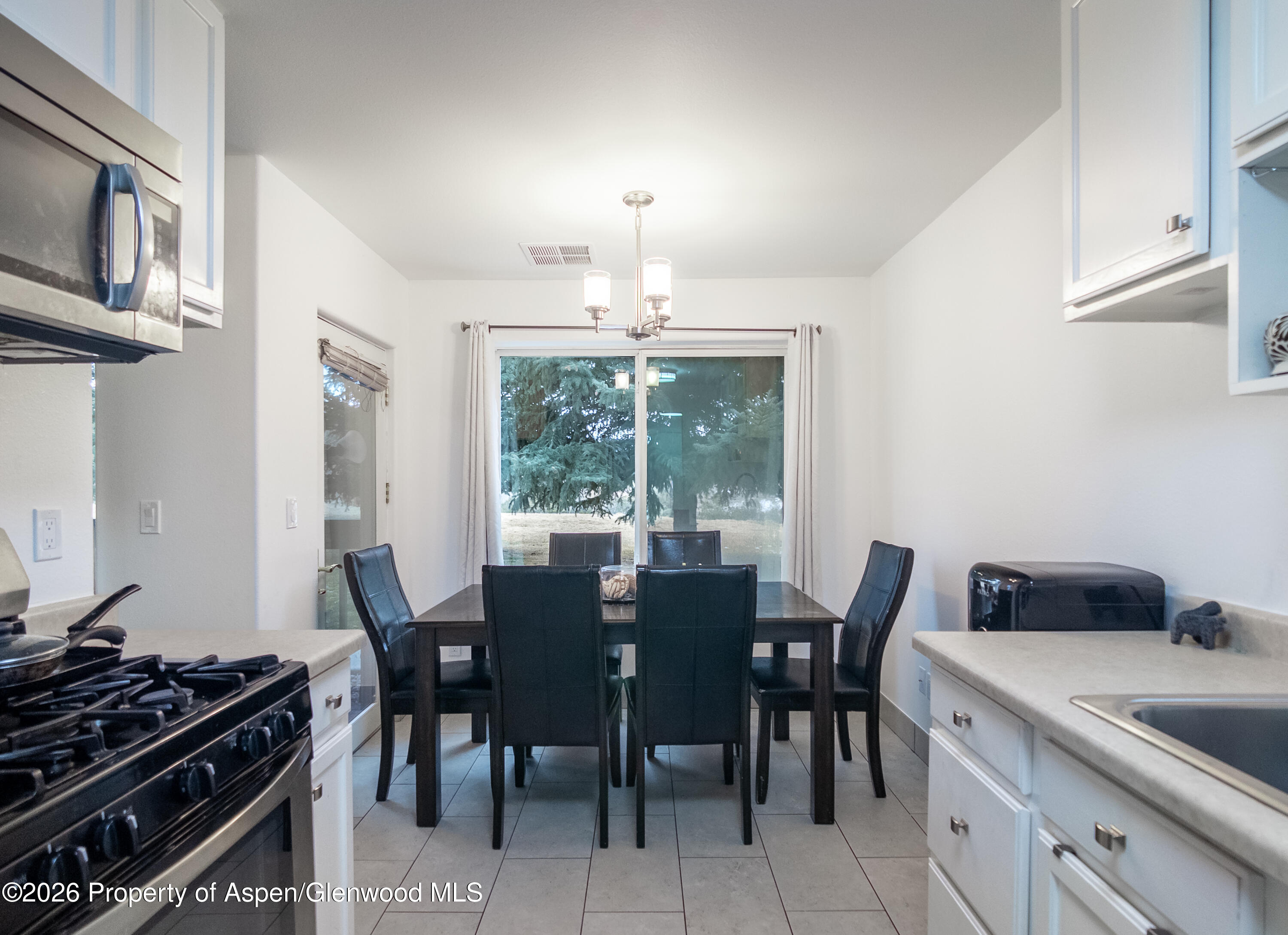 792 Castle Valley Boulevard, Unit B New Castle, CO 81647 - Photo 12 of 25 a view of a dining room with furniture window and outside view