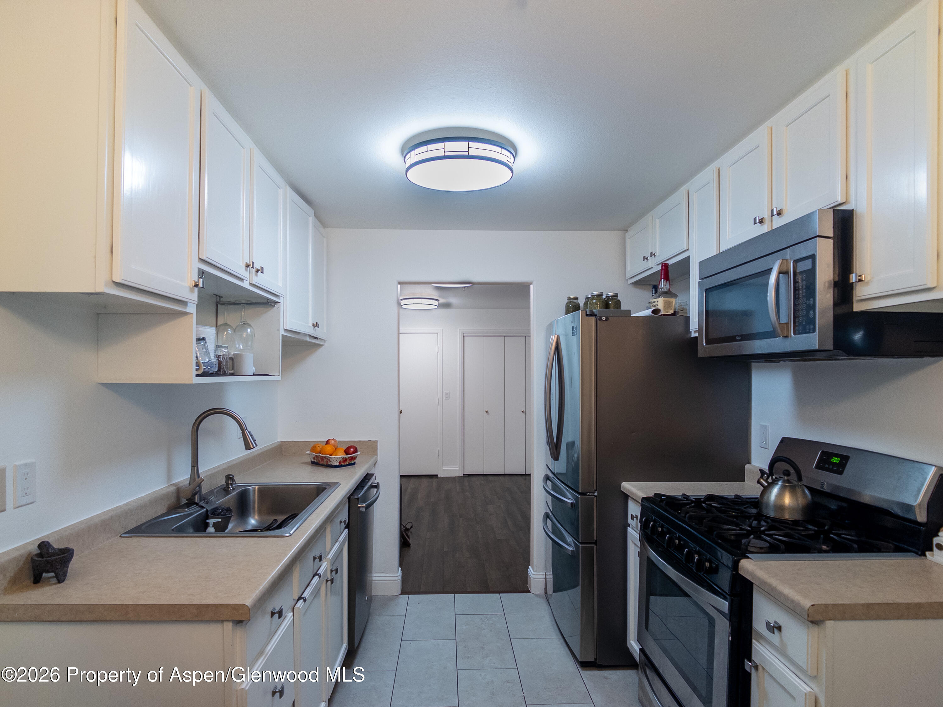 792 Castle Valley Boulevard, Unit B New Castle, CO 81647 - Photo 13 of 25 a kitchen with stainless steel appliances granite countertop a sink stove and refrigerator
