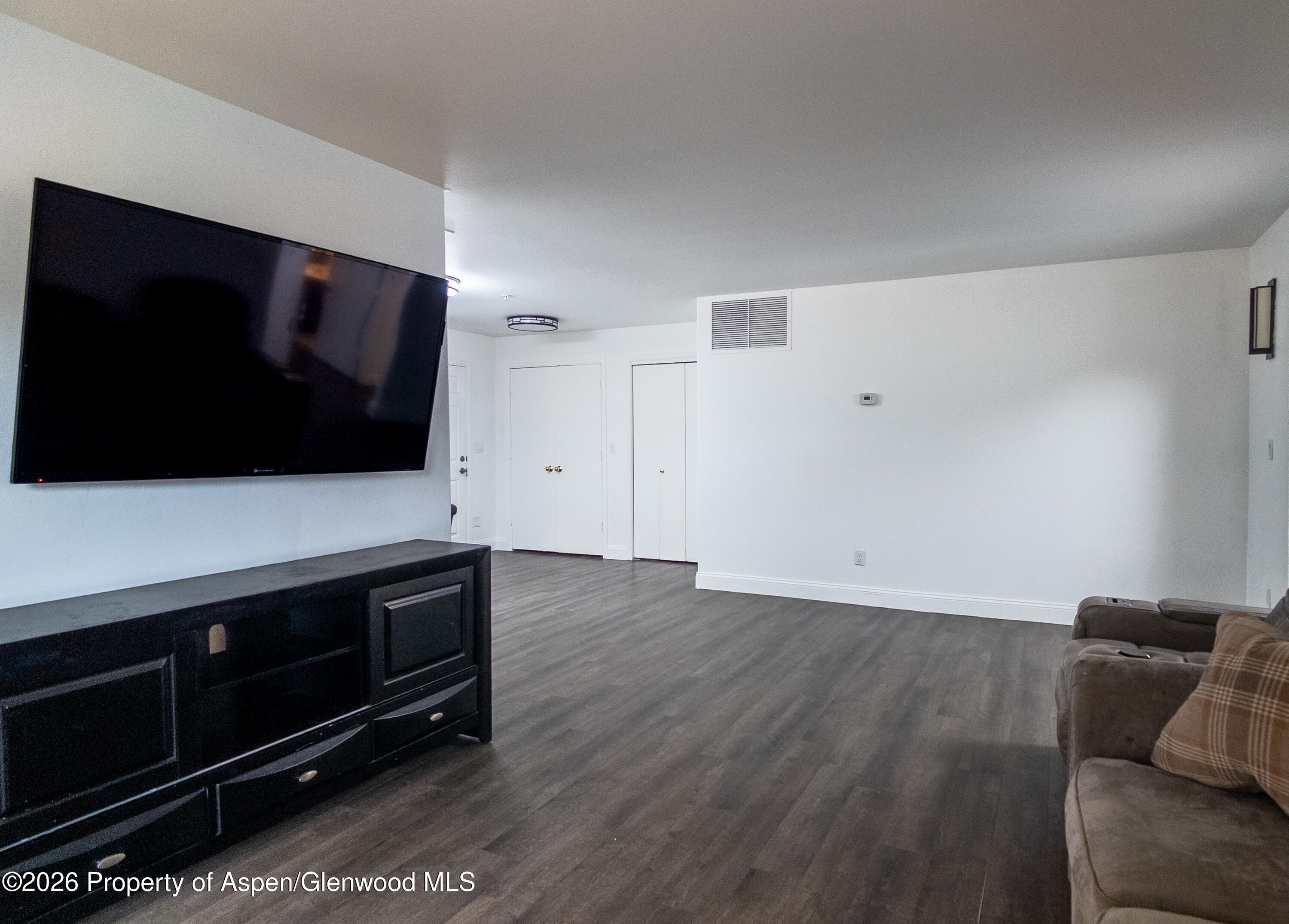 792 Castle Valley Boulevard, Unit B New Castle, CO 81647 - Photo 14 of 25 a living room with hard wood floors and a flat screen tv
