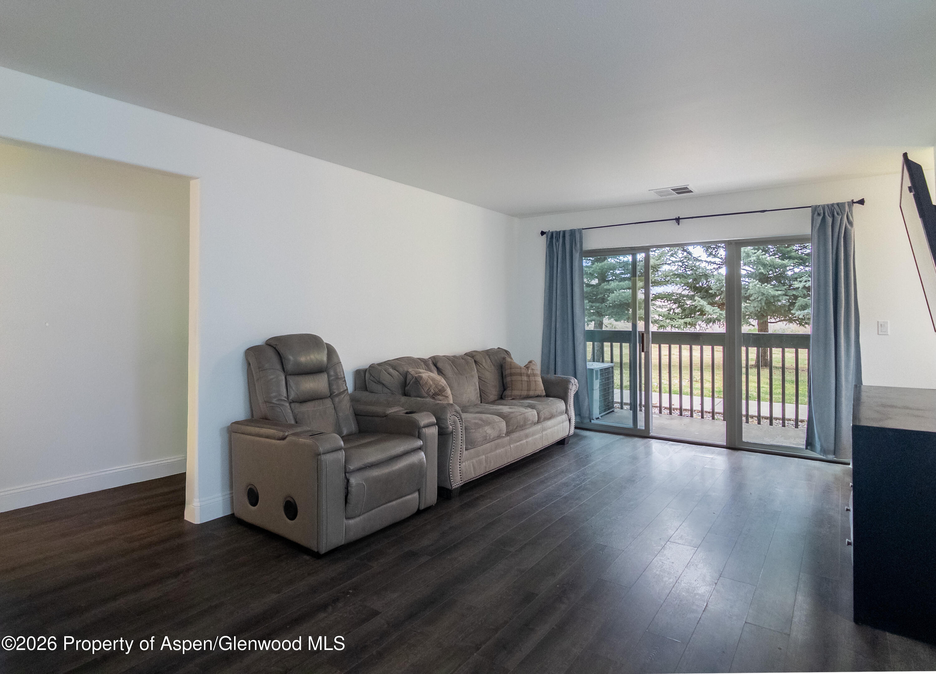 792 Castle Valley Boulevard, Unit B New Castle, CO 81647 - Photo 2 of 25 a living room with furniture and a large window