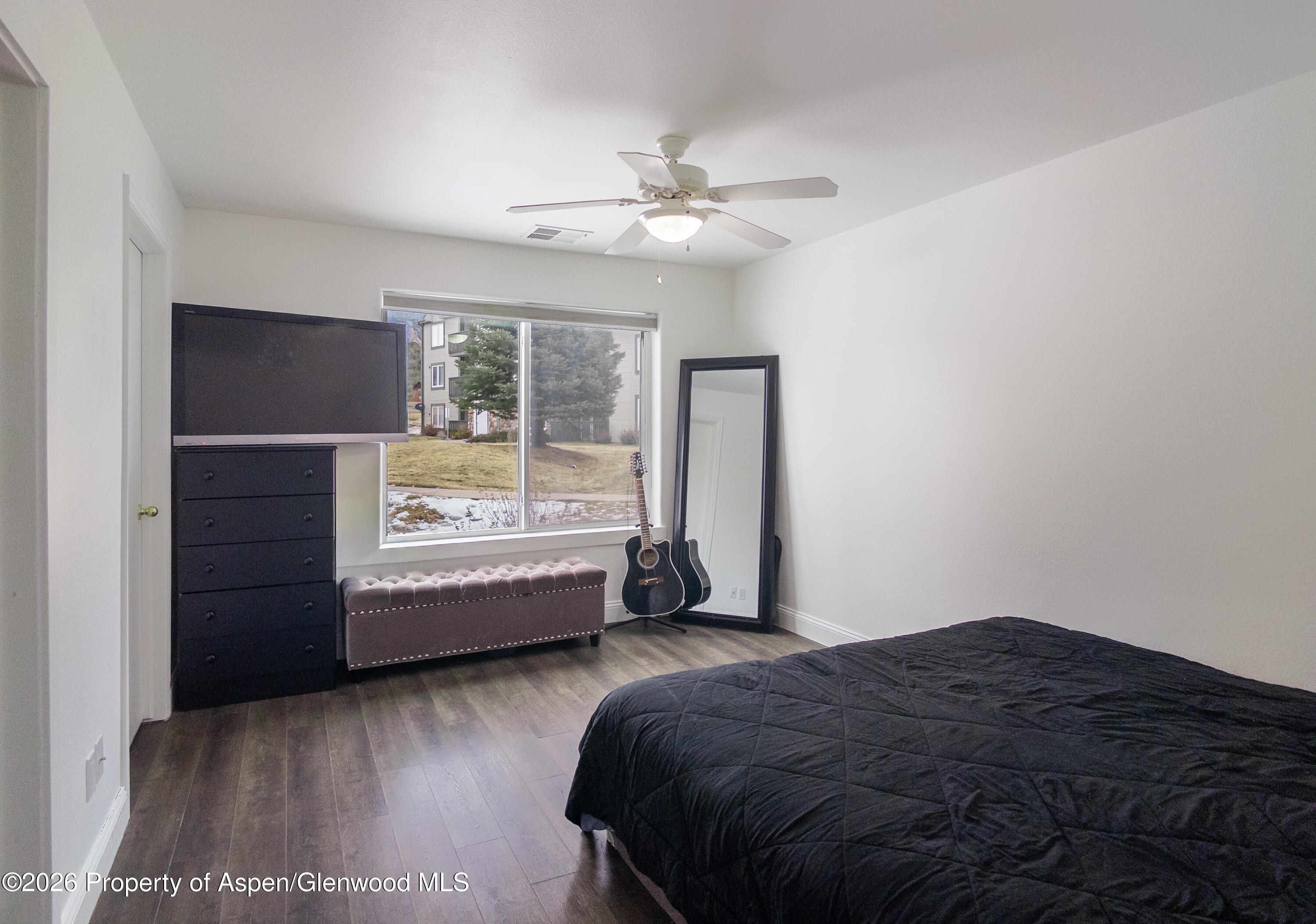 792 Castle Valley Boulevard, Unit B New Castle, CO 81647 - Photo 3 of 25 a bedroom with a bed and a window