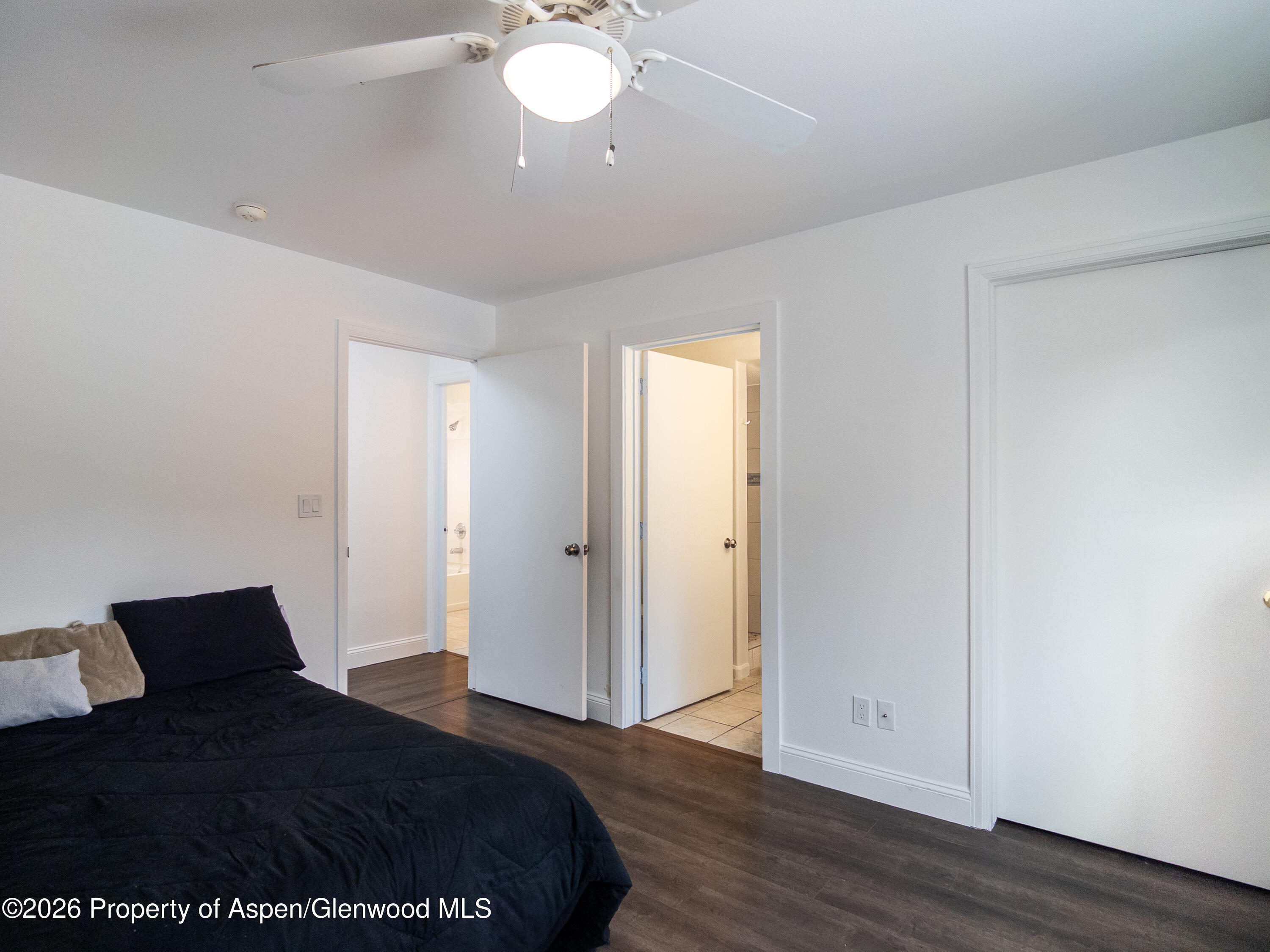 792 Castle Valley Boulevard, Unit B New Castle, CO 81647 - Photo 7 of 25 a bedroom with a bed and wooden floor