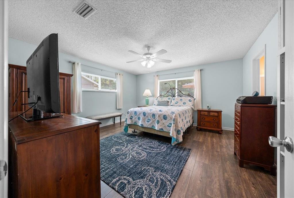 8720 Southwest 90th Street, Unit A Ocala, FL 34481 - Photo 31 of 71 a bedroom with a bed and wooden floor