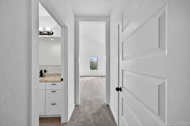 a view of empty room with wooden floor and ceiling fan