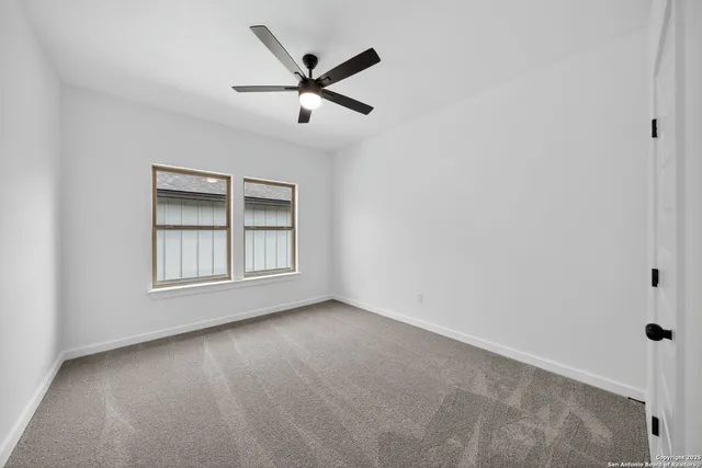 an empty room with windows and entrance