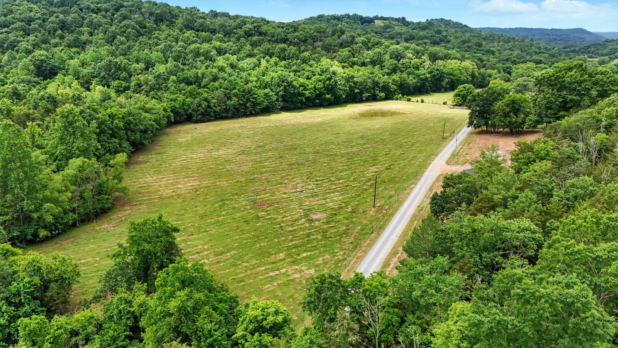124 Blue Smith Road Petersburg, TN 37144 - Photo 2 of 49 a view of a large garden with lawn chairs and large trees