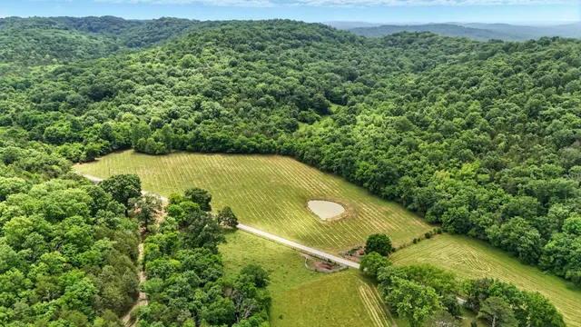 an aerial view of a houses with a yard
