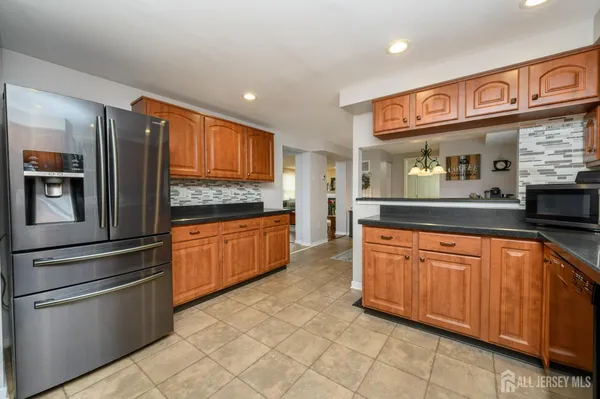 a kitchen with stainless steel appliances granite countertop a refrigerator and stove