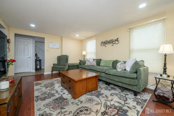 a living room with furniture and a lamp