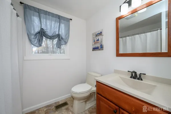 a bathroom with a sink a mirror and a toilet