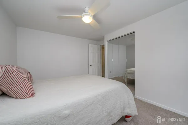 a bedroom with a bed and a lamp