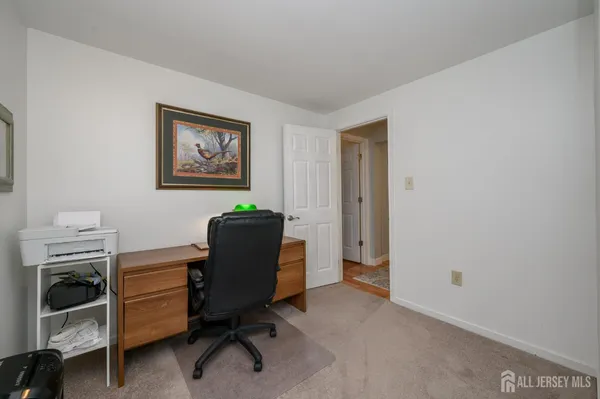 a view of a workspace with furniture and a window