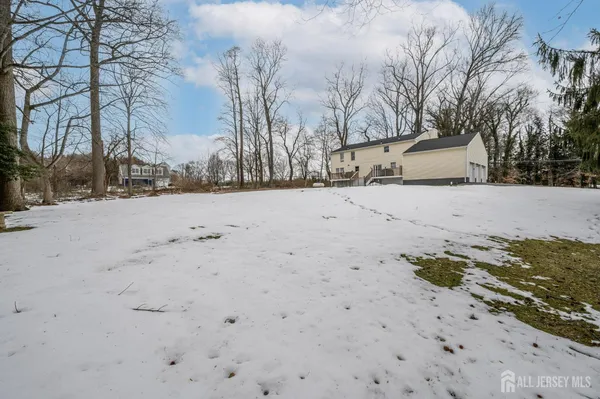 a view of a house with snow on the road