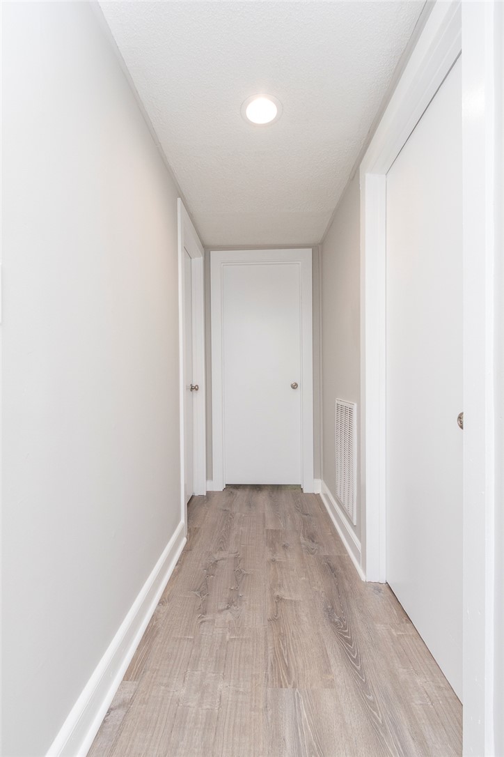 1317 East Broad Street Iva, SC 29655 - Photo 13 of 29 A well-lit corridor boasts contemporary flooring and recessed lighting.