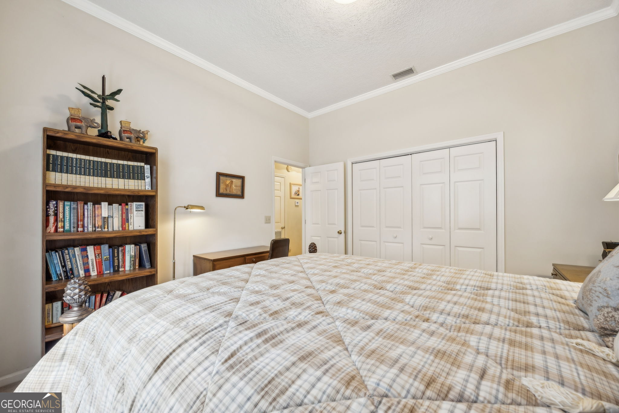 223 Cardinal Circle West St. Marys, GA 31558 - Photo 22 of 54 a bedroom with a bed and a book shelf