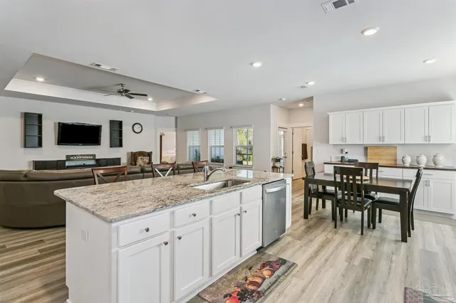 a kitchen with a table chairs microwave and cabinets