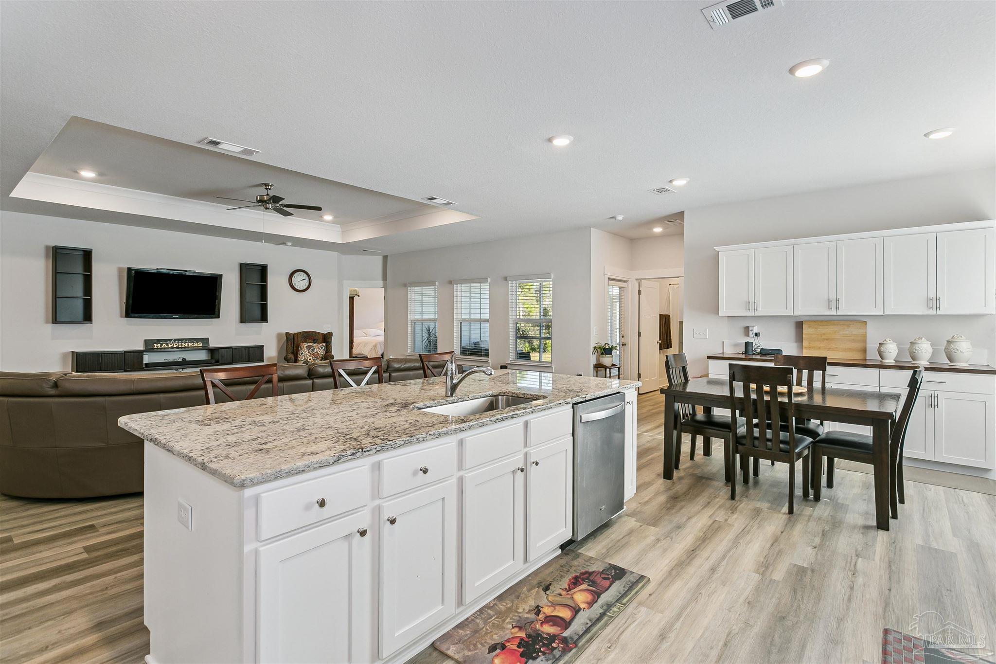 6580 Forest Bay Avenue Gulf Breeze, FL 32563 - Photo 12 of 29 a kitchen with a table chairs microwave and cabinets