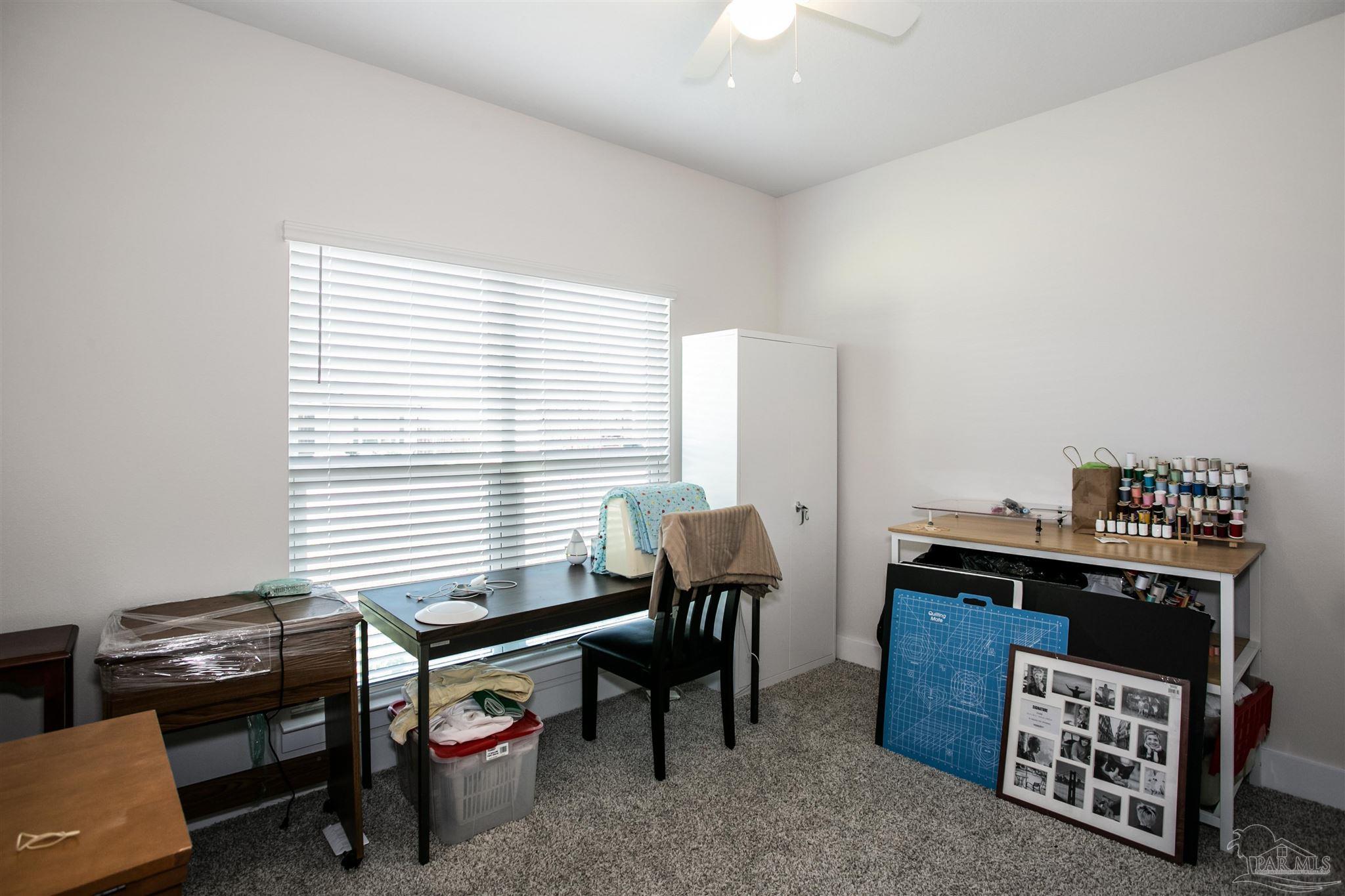 6580 Forest Bay Avenue Gulf Breeze, FL 32563 - Photo 15 of 29 a livingroom with workspace and a window