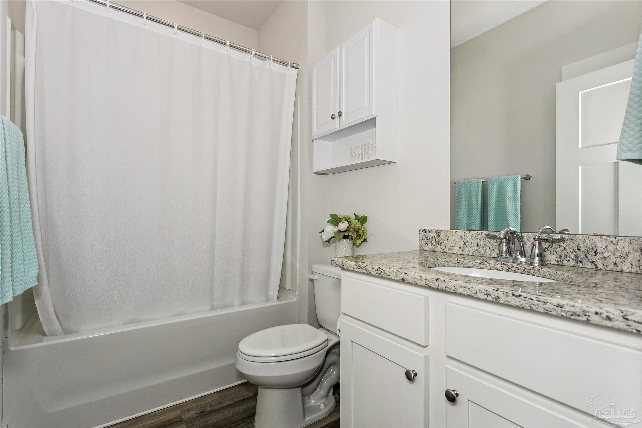 6580 Forest Bay Avenue Gulf Breeze, FL 32563 - Photo 16 of 29 a bathroom with a granite countertop sink toilet and shower