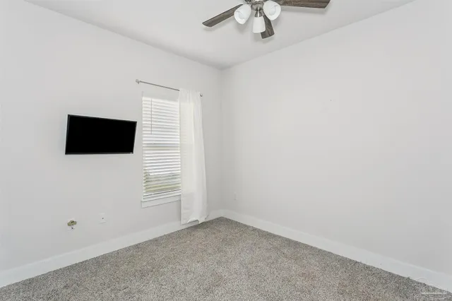 a view of empty room with ceiling fan