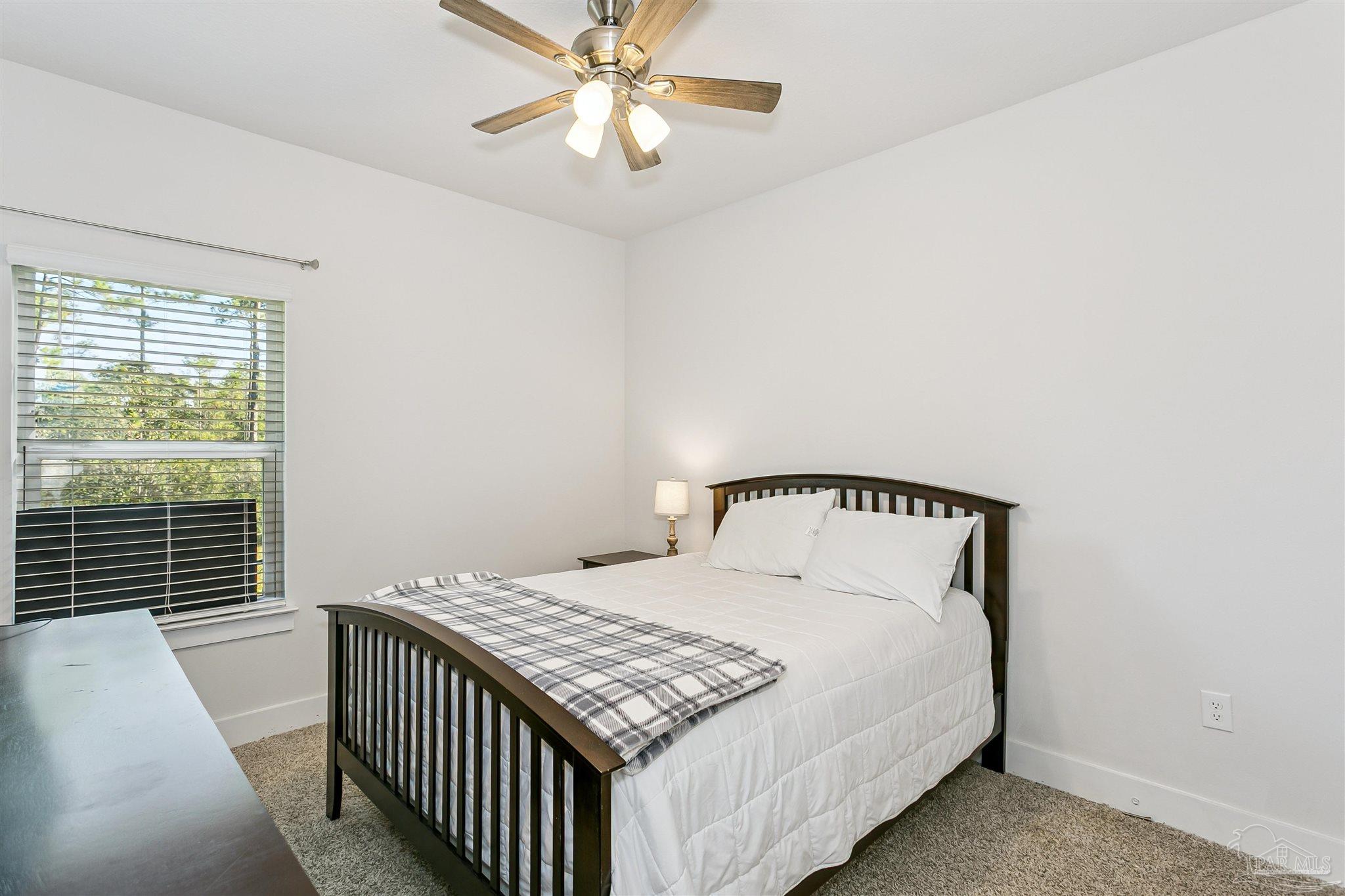 6580 Forest Bay Avenue Gulf Breeze, FL 32563 - Photo 18 of 29 a bedroom with a bed and a window