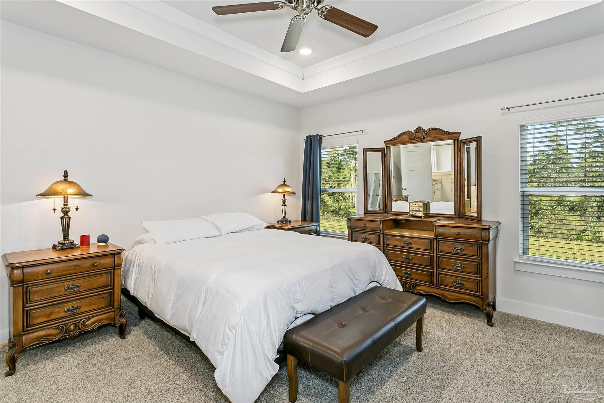 6580 Forest Bay Avenue Gulf Breeze, FL 32563 - Photo 21 of 29 a bedroom with a bed and large windows