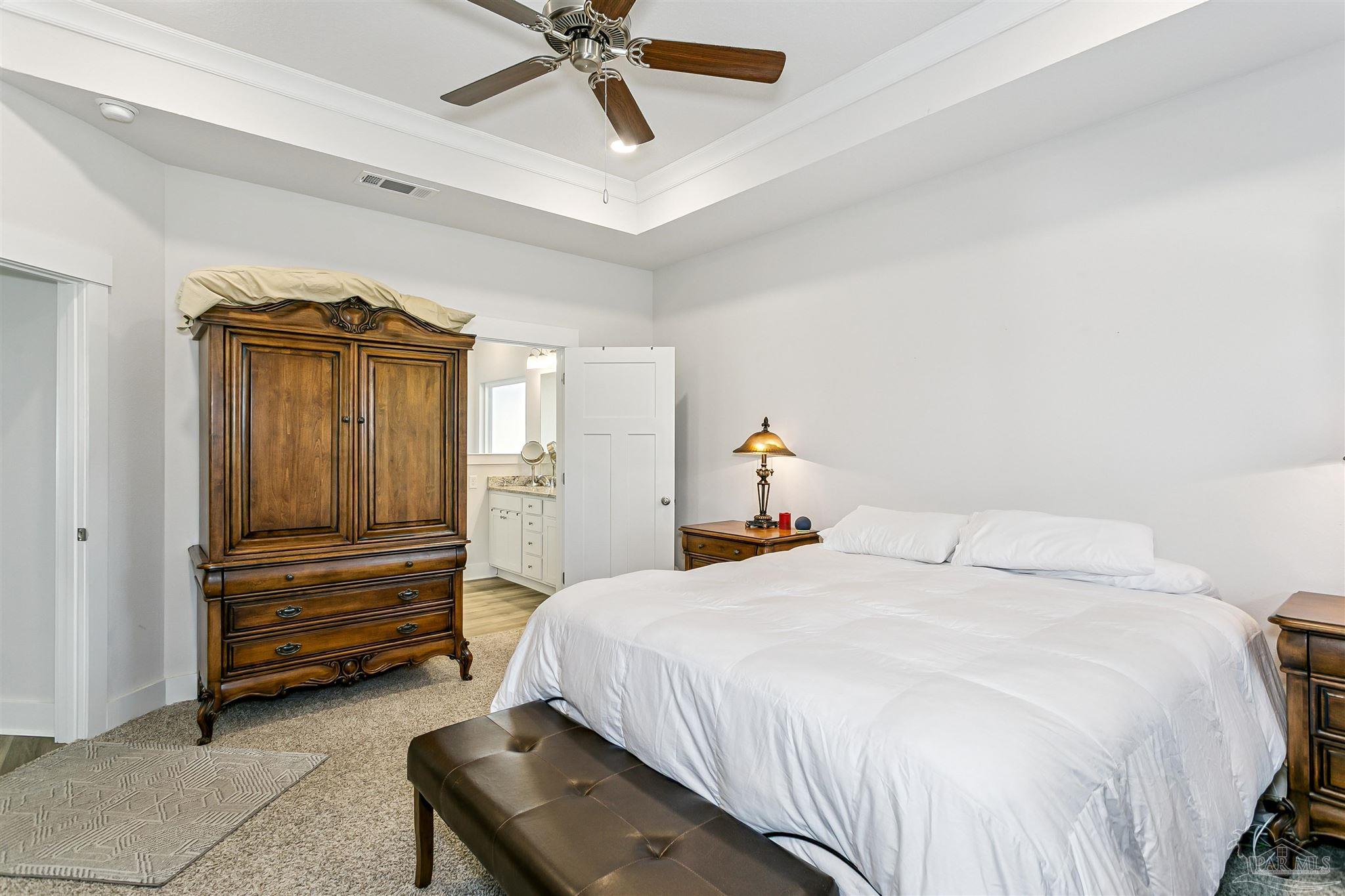 6580 Forest Bay Avenue Gulf Breeze, FL 32563 - Photo 22 of 29 a bedroom with a bed and cabinets