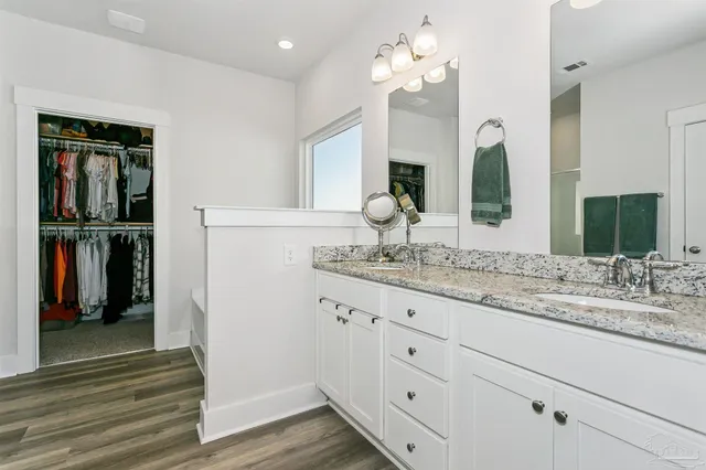 a bathroom with double vanity sink and a mirror