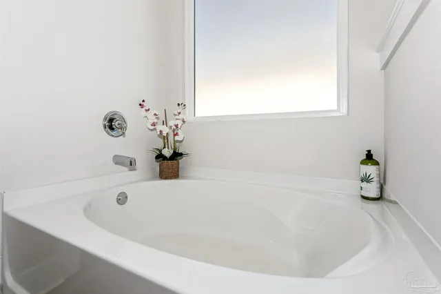 a white bath tub sitting in a bathroom