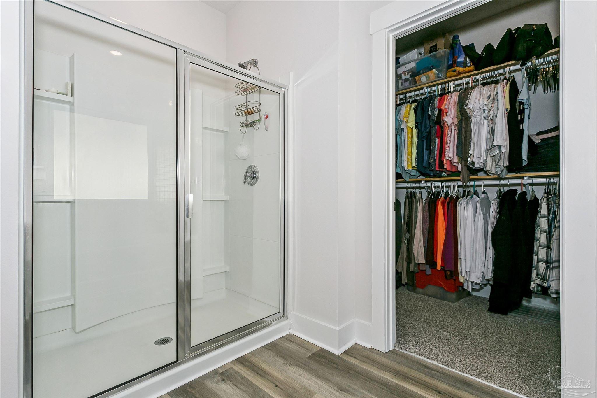 6580 Forest Bay Avenue Gulf Breeze, FL 32563 - Photo 25 of 29 a view of walk in closet with clothes and shoes