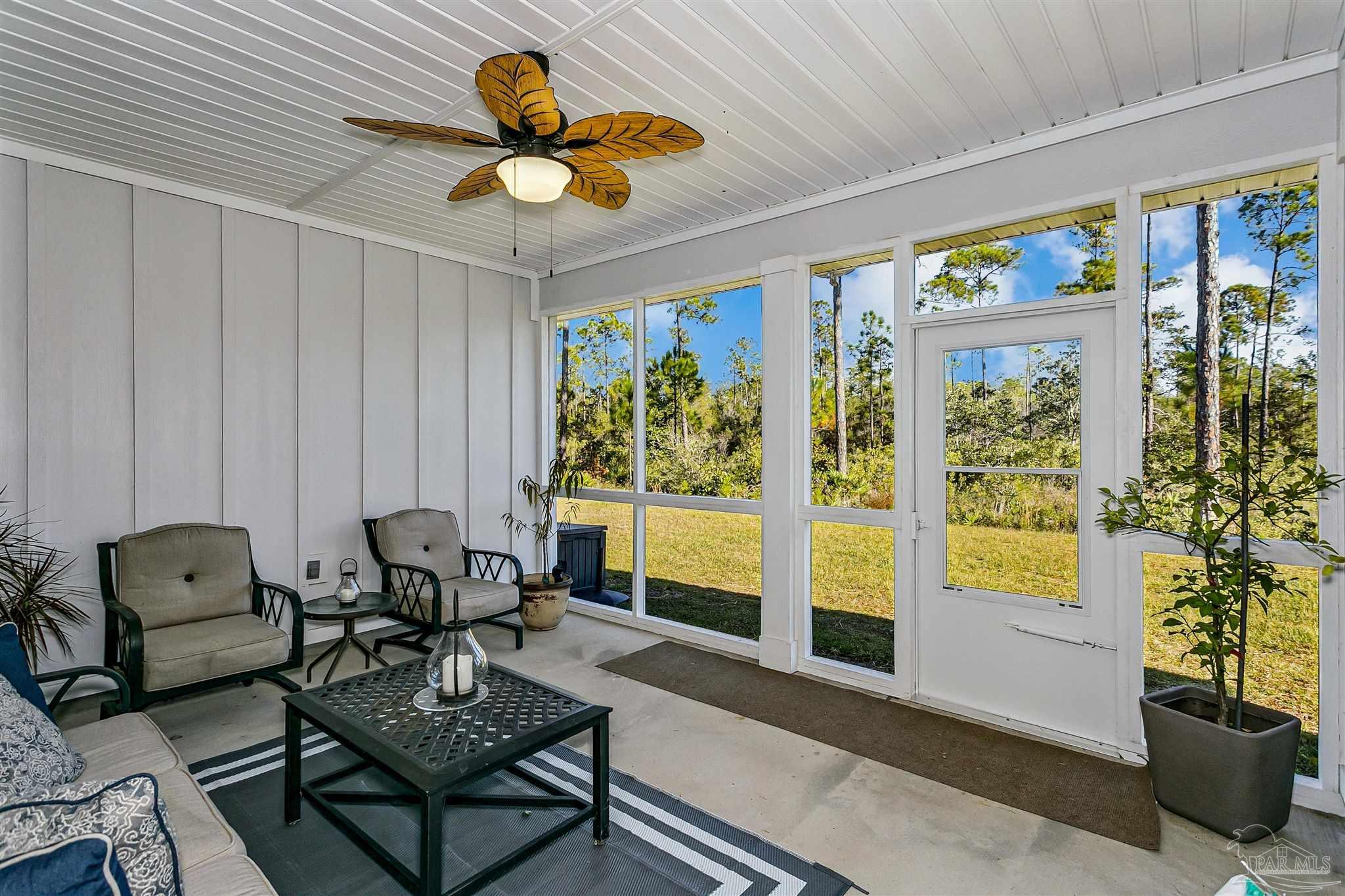 6580 Forest Bay Avenue Gulf Breeze, FL 32563 - Photo 27 of 29 a living room with furniture and a large window