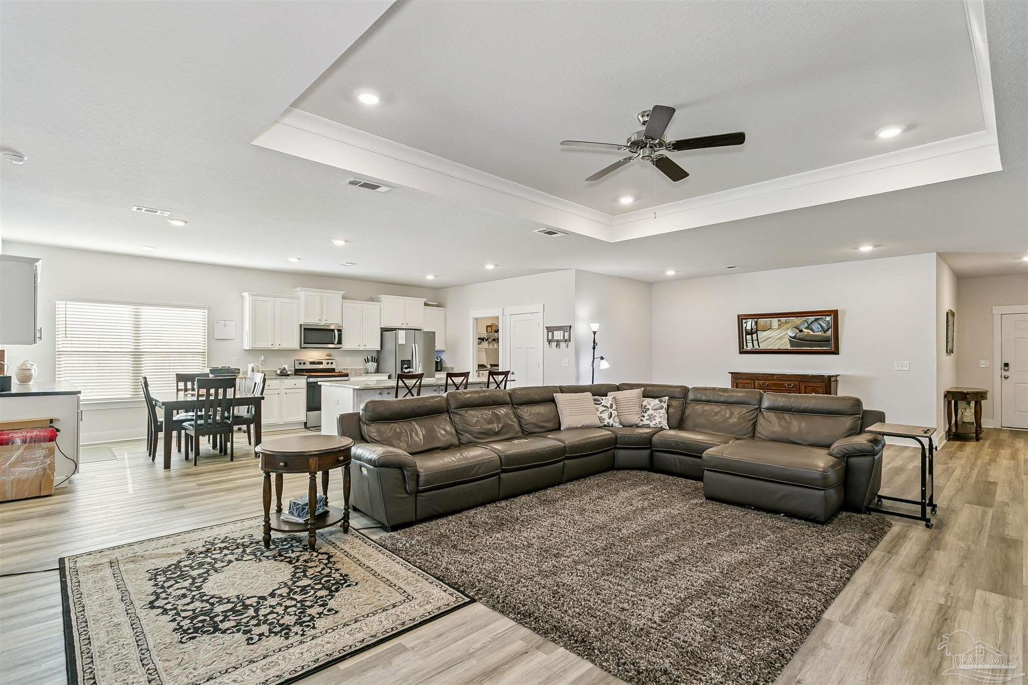 6580 Forest Bay Avenue Gulf Breeze, FL 32563 - Photo 6 of 29 a living room with furniture a rug and a table