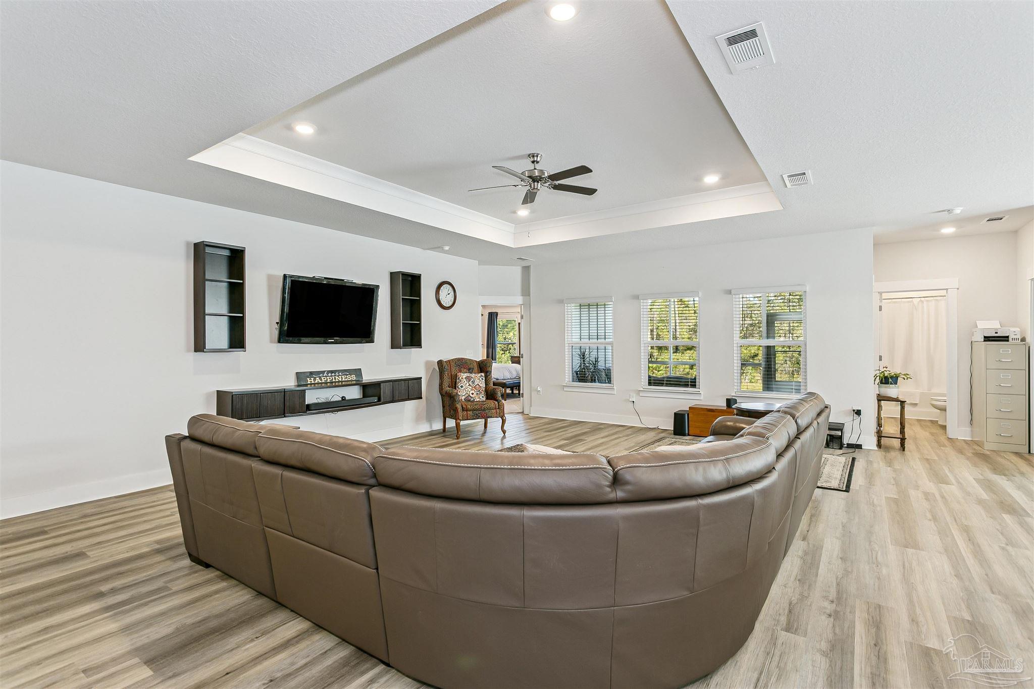 6580 Forest Bay Avenue Gulf Breeze, FL 32563 - Photo 7 of 29 a living room with fireplace furniture and a flat screen tv