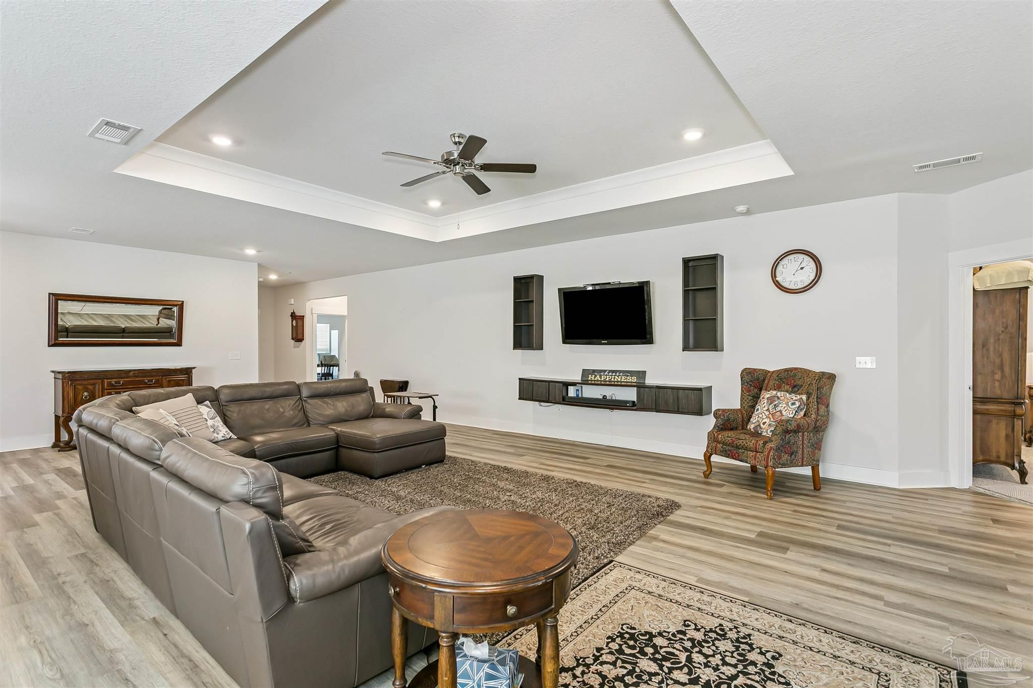 6580 Forest Bay Avenue Gulf Breeze, FL 32563 - Photo 8 of 29 a living room with furniture and a flat screen tv