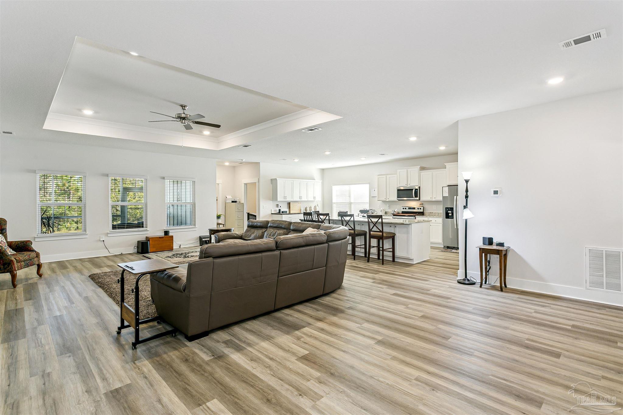 6580 Forest Bay Avenue Gulf Breeze, FL 32563 - Photo 9 of 29 a living room with furniture and a wooden floor