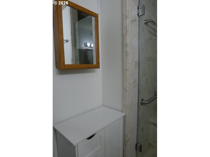 412 Camellia Court Reedsport, OR 97467 - Photo 28 of 48 a picture of a bathroom with a sink and mirror