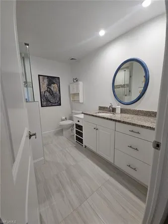 a spacious bathroom with a double vanity sink and a mirror